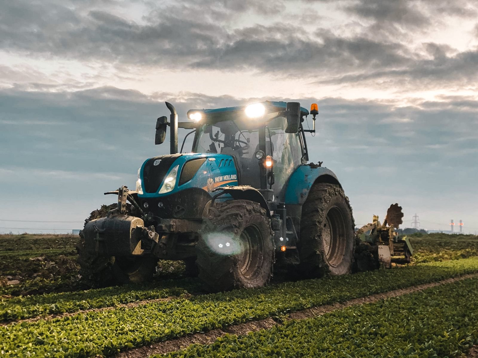 Tractor working a field at dusk