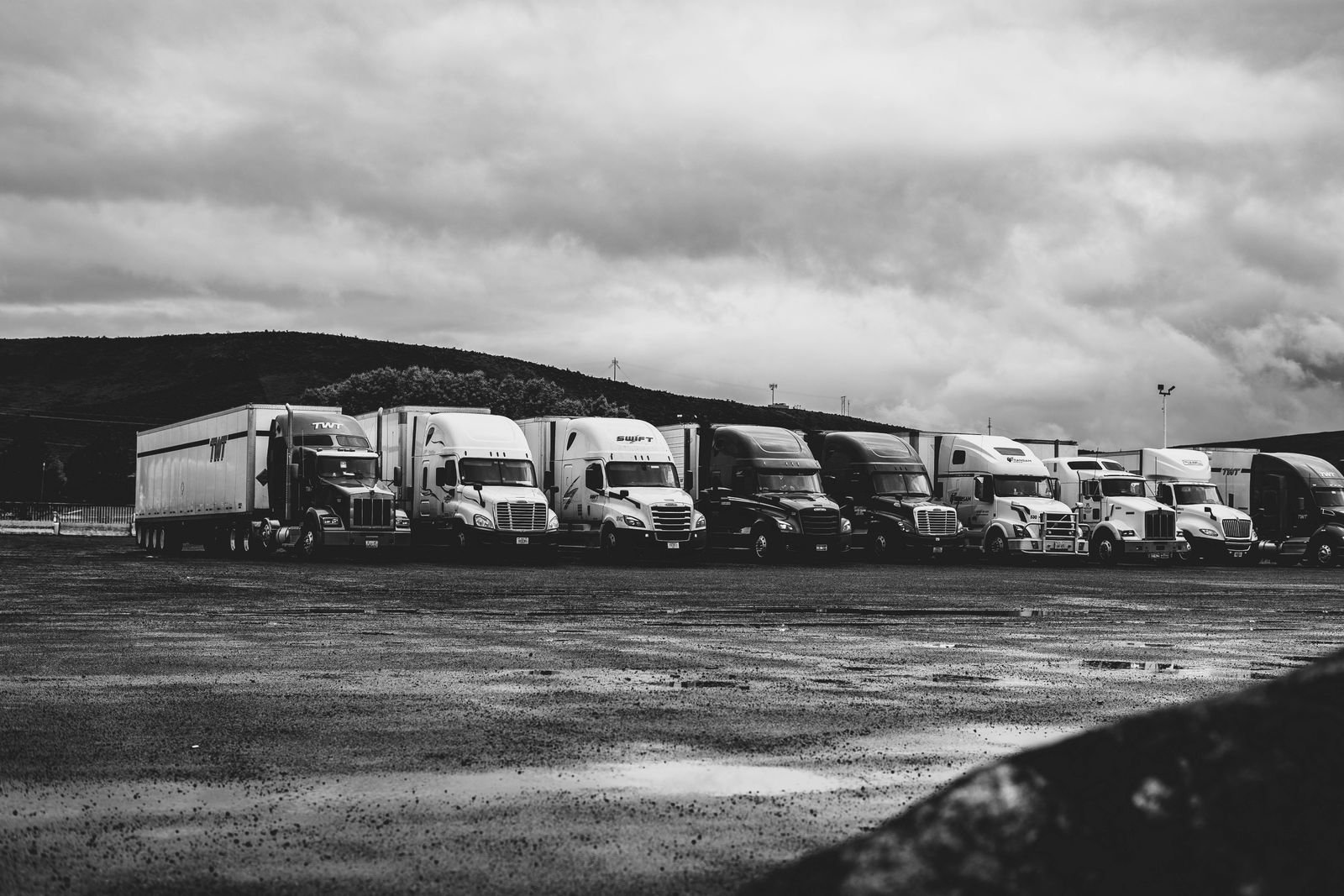 Fleet of heavy trucks parked in line